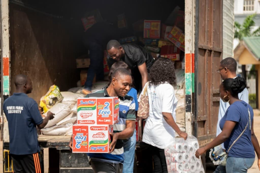 Team members unloading food and household supplies for the children